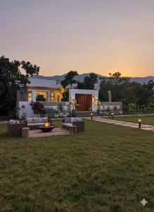 a house with a lawn in front of it at Privé Residence in Rāmnagar