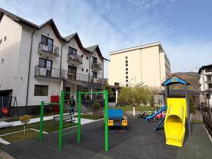 a playground in front of a building with at GRAND Caciulata in Caciulata