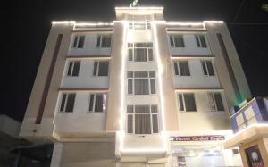 a tall white building with lights on it at Hotel Grand Eagle Group in Jaipur +20 photos