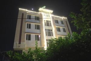 a white building with lights on it at night at Hotel Grand Eagle Group in Jaipur