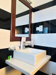 a bathroom with a white sink and a mirror at O2 Resort Welimada in Nugatalawa