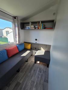 a living room with a couch and a window at Moon Lodge in Koksijde
