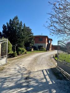 a driveway with a gate in front of a house at Villa Giulia apartment Assisi in Castelnuovo +29 photos