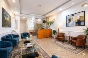 a living room with blue couches and chairs at Gia Khanh Hotel in Da Lat