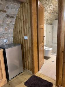 a bathroom with a sink and a refrigerator at Jeanette's Home in Berat