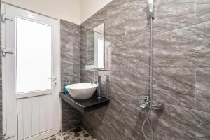 a bathroom with a sink and a shower at Gia Khanh Hotel in Da Lat