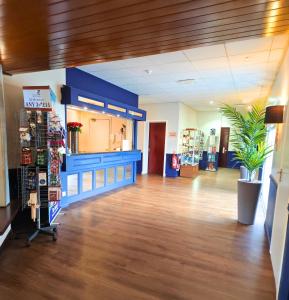 a lobby of a store with a potted plant at The Caledonian Claymore Hotel in Arrochar