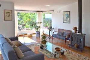 a living room with a couch and a fireplace at Quatre vents Ref 163 in Begur