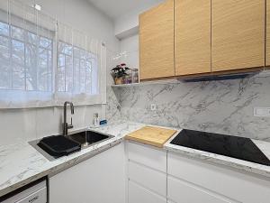 a kitchen with a sink and a counter top at Mar Blau Estartit Rental in L'Estartit