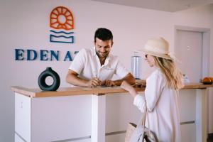 a man and a woman standing at a kitchen counter at Eden Azur - Résidence Hôtelière in Golfe-Juan +22 photos