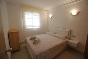a bedroom with a bed with two towels on it at Apartment La Turquesa in La Pineda +43 photos