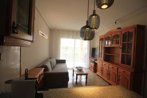 a living room with a couch and a table at Apartment La Turquesa in La Pineda