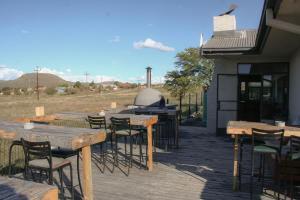a group of tables and chairs on a patio at Heydays B&B in Noupoort