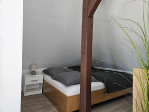 a bedroom with a bunk bed with a wooden bed frame at Ferienwohnungen Stadtblick, 15208 - Nur für Urlaubsgäste! in Leer