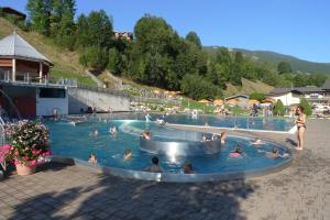 a group of people swimming in a swimming pool at Ferienwohnung Loitfelder-Pang in Saalbach-Hinterglemm