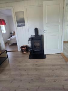 a living room with a stove in a room at Cabin in Leirvåg in Leirvåg