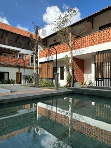 a house with a pool in front of a building at Griya Yunika in Yogyakarta