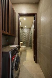 a bathroom with a washer and dryer in a room at Amy Apartment Hue in Hue +112 photos