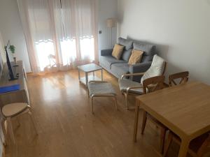 a living room with a couch and a table at El Cierrón - apartamento con terrazas! in Villaviciosa
