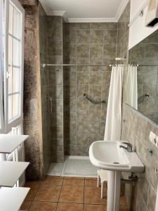 a bathroom with a shower and a sink at La Casa de la Plaza in Cee +50 photos