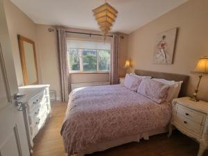 a bedroom with a bed and a window at Rosemount in Sligo