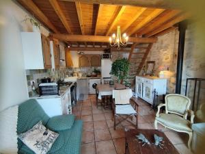 a kitchen with a couch and a table in a room at à 10 mn des Gorges de l'Ardèche in Bidon
