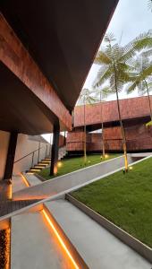 an external view of a building with a courtyard with palm trees at Maisola by ARTOTEL Semarang in Semarang