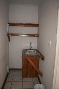 a bathroom with a sink in the corner of a room at Heydays B&B in Noupoort +90 photos