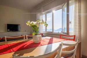 a dining room table with a vase of flowers on it at Al Pianaccio by Lago Reisen in Trarego Viggiona