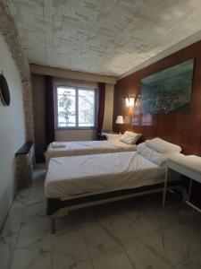 a bedroom with two beds and a window at Sci LS in Fresnes
