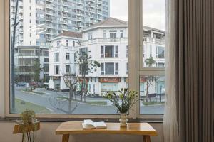 a table in front of a window with a view of a city at Amy Apartment Hue in Hue
