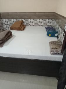 a large bed in a room with pillows on it at Shri Shyama seva kunj in Vrindāvan