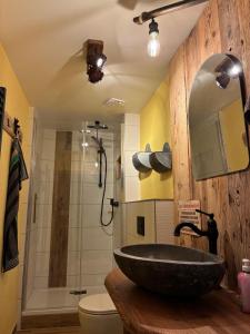 a bathroom with a stone sink and a shower at Ferienhaus Hutznhaisl in Bärenstein +6 photos