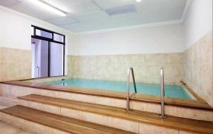 a swimming pool in a room with a large window at Built on Hope De Waterkant in Cape Town