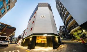 a building with an ak sign on the side of a street at 신촌 APL Hotel in Seoul