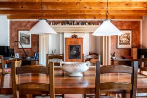 a dining room with a wooden table and two pendant lights at B&B Il Pettirosso in Negrar