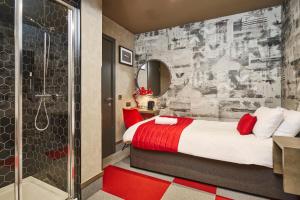 a bedroom with a red and white bed and a shower at The Pier Rooms in Oban