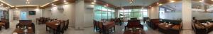 a restaurant with tables and chairs in a room at Scenic Hotel Near Earthquake Memorial Bridge,203 in Muzaffarabad