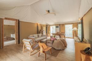 a living room with a couch and a table at The Vineyard Hideaway Khaoyai in Ban Wang Phaem