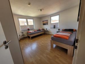 a bedroom with a bed and a couch and windows at Charlotte II in Neustadt bei Coburg
