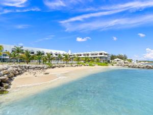 a view of the beach in front of the resort at Ocean Breeze, Fully Renovated Beachfront 2 bdr in Baie Nettle