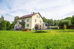 a house with a playground in the yard at Haus Heidi mit Balkon in Moosbach