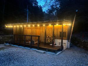 a building with lights on top of it at night at 掘っ立て小屋遊々 in Mine