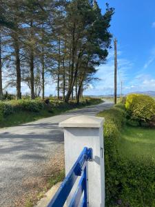 a blue and white gate on the side of a road at The Cottage in Ramelton