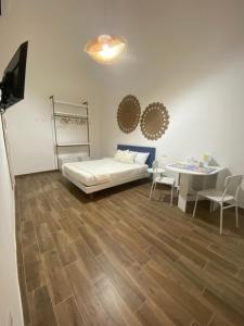 a bedroom with a bed and a table and a desk at Emme9 in Gaeta