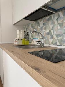 a kitchen with a sink and a counter top at Emme9 in Gaeta +26 photos