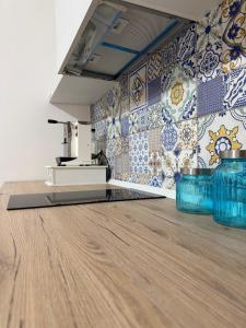 a kitchen with blue tiles on the wall at Emme9 in Gaeta