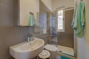 a bathroom with a sink and a toilet and a shower at Casa Bianca - Goelba in Pomonte +40 photos