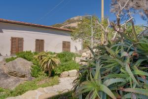 a garden in front of a white building at Casa Bianca - Goelba in Pomonte