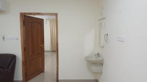 a bathroom with a toilet and a sink at Hotel Tamilnadu Trichy in Tiruchirappalli +87 photos